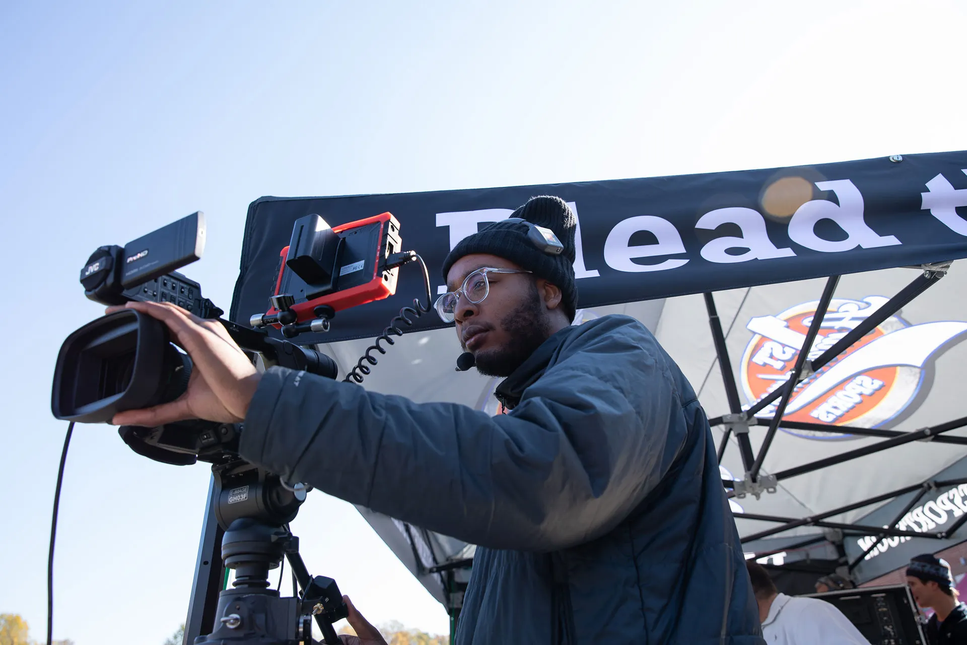 A production switcher and monitor wall during a live broadcast.